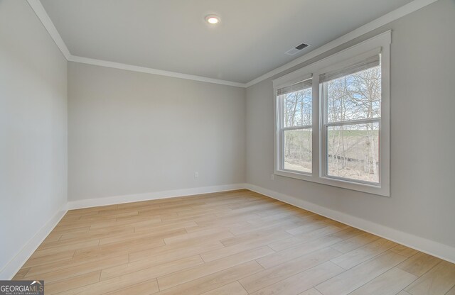 empty room featuring carpet flooring, ornamental molding, and a tray ceiling