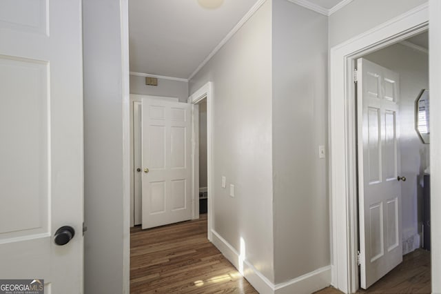 hallway with ornamental molding and dark hardwood / wood-style flooring