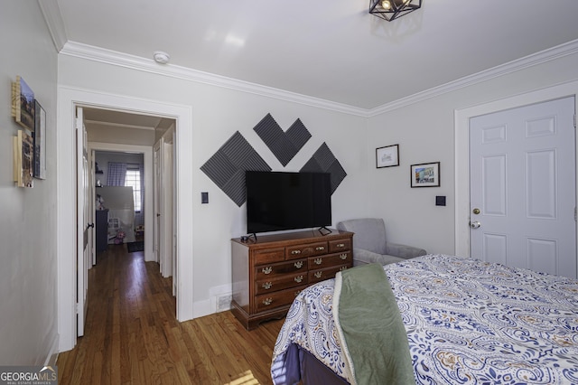 bedroom featuring ornamental molding and dark hardwood / wood-style floors