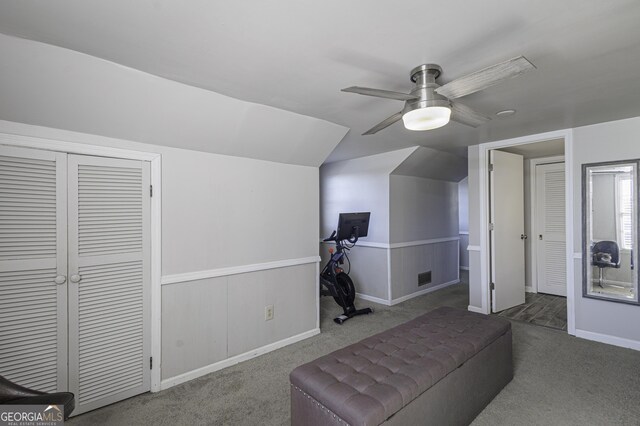 interior space with vaulted ceiling, ceiling fan, and carpet