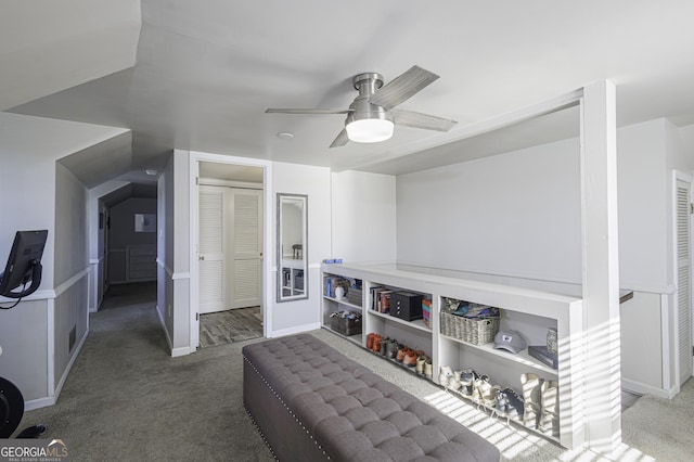 interior space with carpet floors and ceiling fan