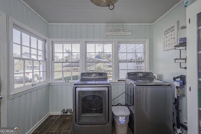 clothes washing area with ornamental molding, dark hardwood / wood-style flooring, and washing machine and dryer