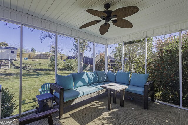 unfurnished sunroom with ceiling fan