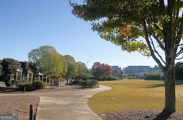 view of home's community featuring a yard and a playground