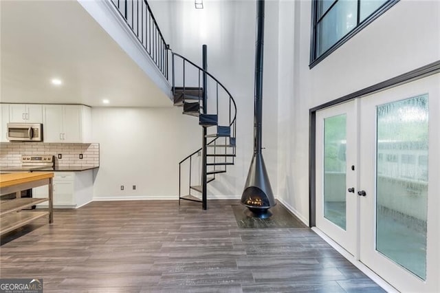 foyer entrance with french doors and dark hardwood / wood-style floors