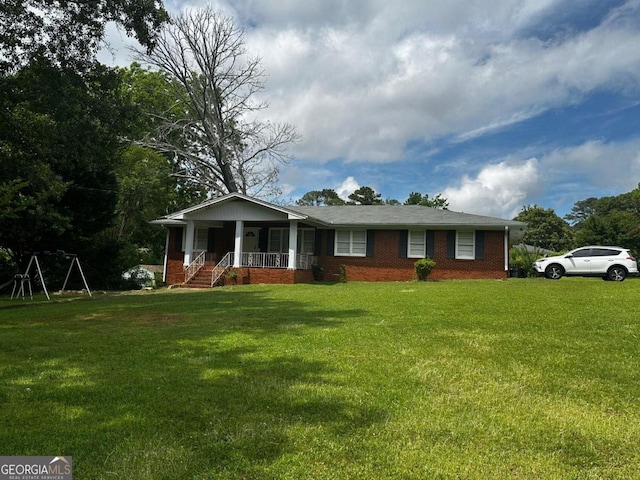 single story home featuring covered porch and a front yard