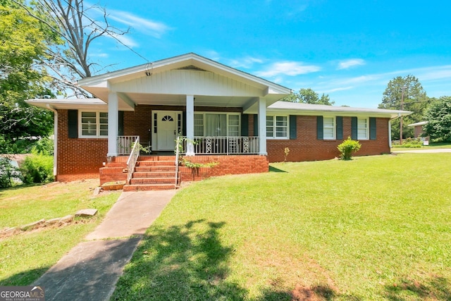 view of front facade featuring a front yard, a porch, and brick siding