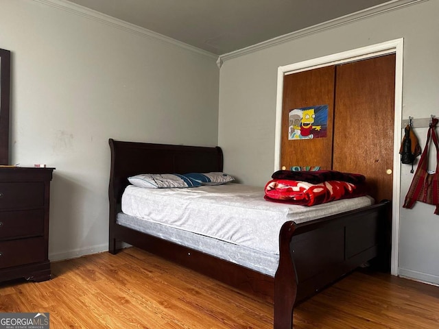 bedroom with ornamental molding and light hardwood / wood-style flooring