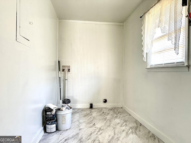 washroom with marble finish floor, laundry area, and baseboards