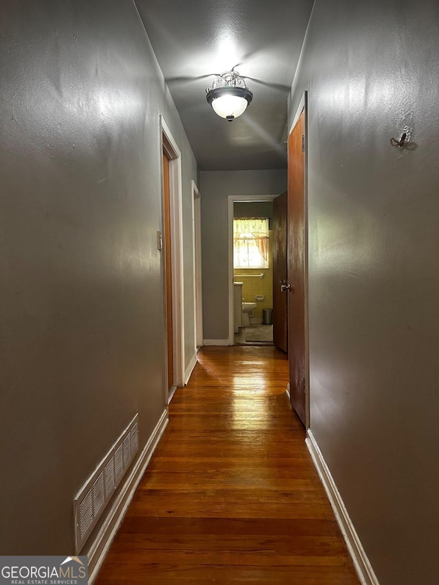 corridor featuring hardwood / wood-style floors