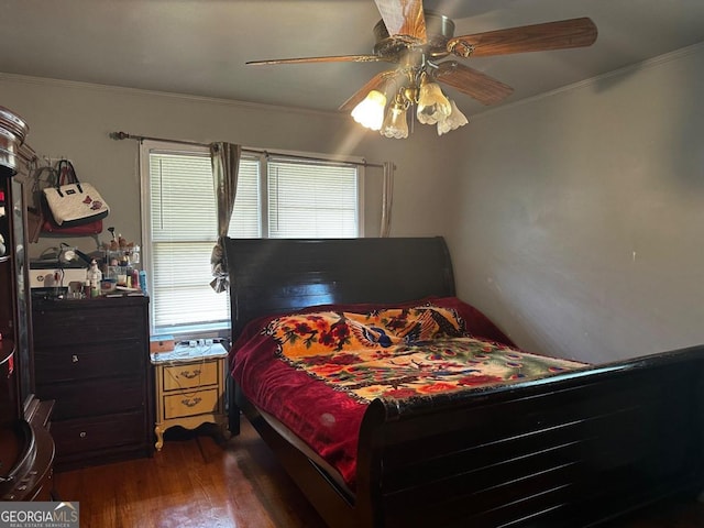 bedroom with dark hardwood / wood-style flooring, ceiling fan, and ornamental molding