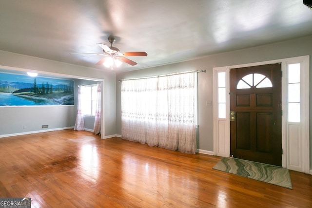 entrance foyer featuring a ceiling fan, baseboards, and wood finished floors