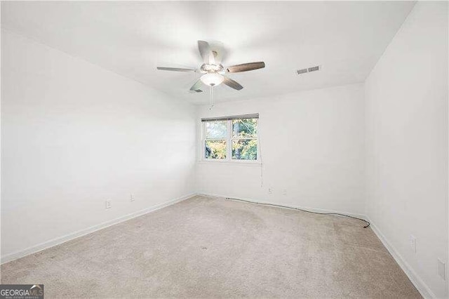 unfurnished room featuring ceiling fan and carpet