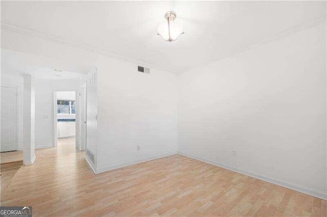 empty room with light hardwood / wood-style flooring