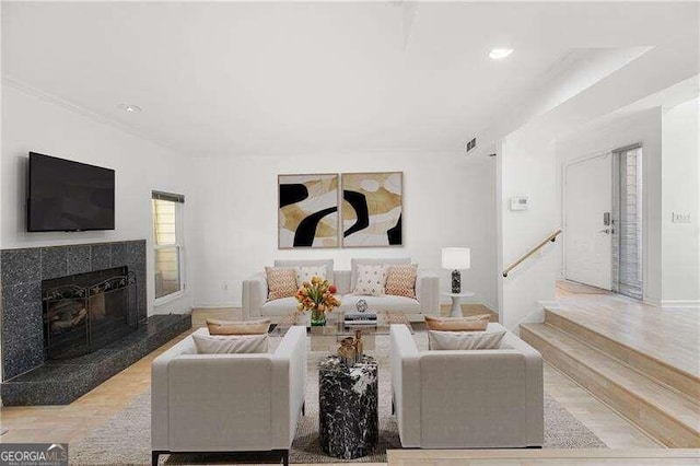 living room with a premium fireplace and light hardwood / wood-style flooring