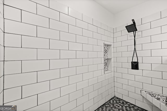 bathroom with a tile shower