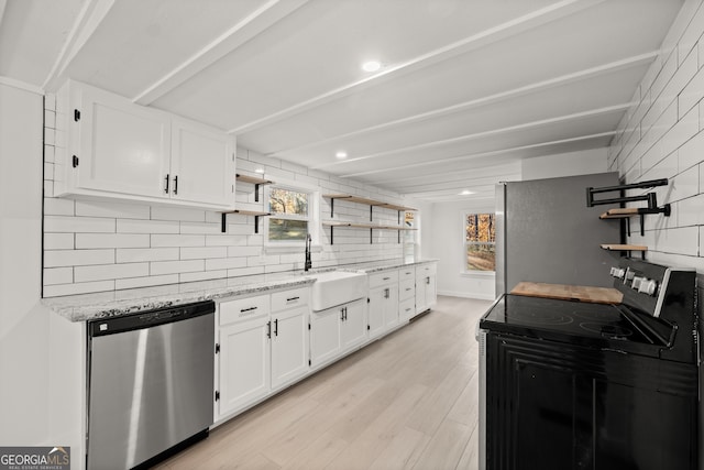 kitchen with appliances with stainless steel finishes, light stone counters, sink, light hardwood / wood-style floors, and white cabinetry