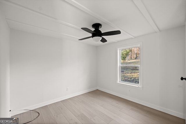 empty room with beam ceiling, ceiling fan, and light wood-type flooring