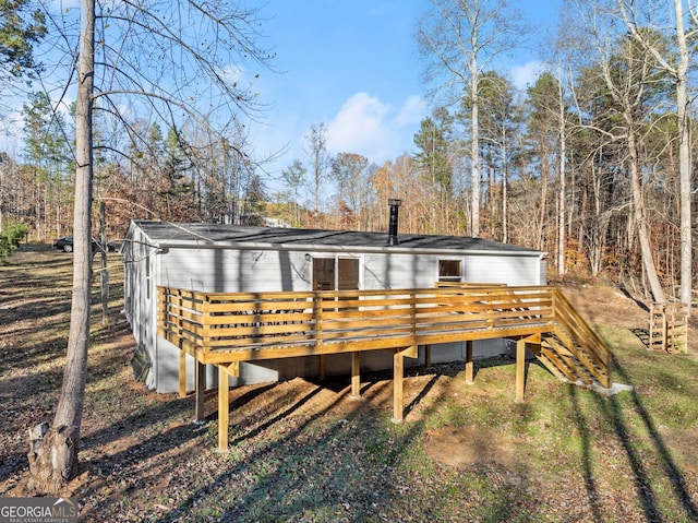 back of property featuring a wooden deck