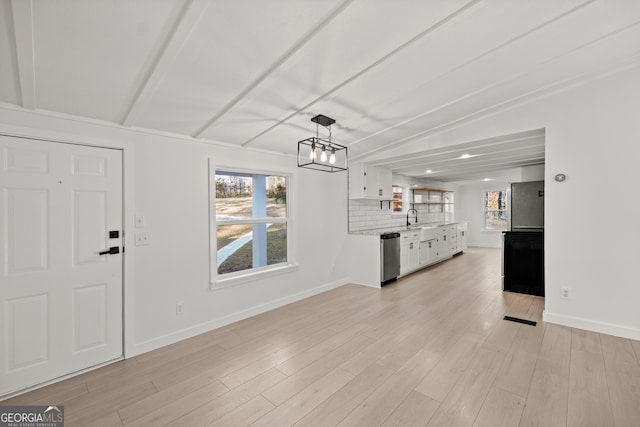 interior space featuring light hardwood / wood-style flooring, beamed ceiling, a notable chandelier, and sink