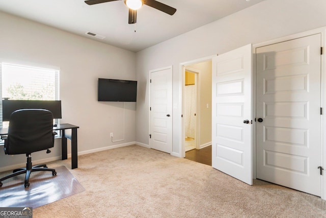 carpeted office featuring ceiling fan