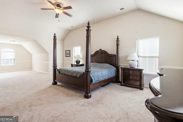 bedroom with light colored carpet, vaulted ceiling, and ceiling fan