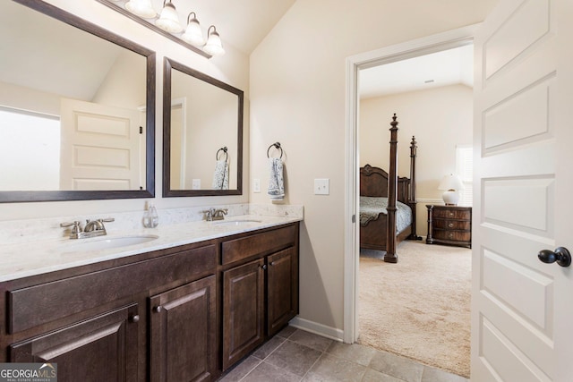 bathroom with vanity and lofted ceiling