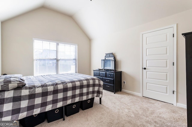 carpeted bedroom featuring vaulted ceiling