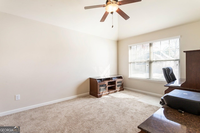 carpeted home office featuring ceiling fan and lofted ceiling