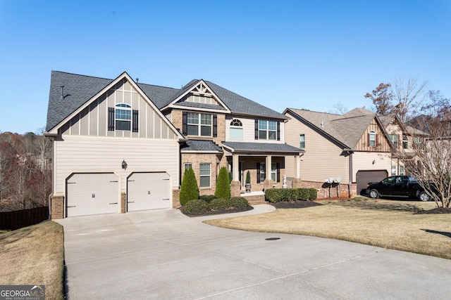 view of front of home featuring a front lawn, a porch, and a garage