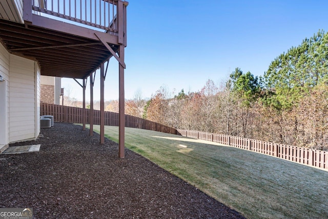 view of yard featuring central AC unit and a wooden deck