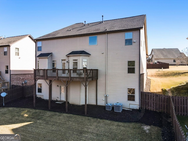 back of property featuring a lawn and central AC unit