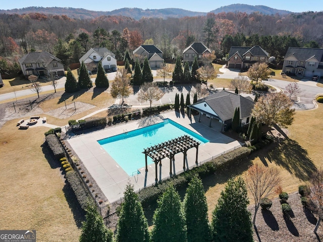 view of swimming pool featuring a pergola, a mountain view, and a patio