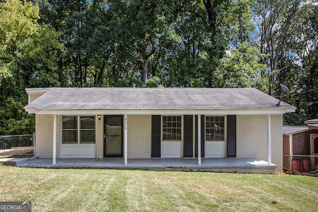 rear view of property with a yard and a porch