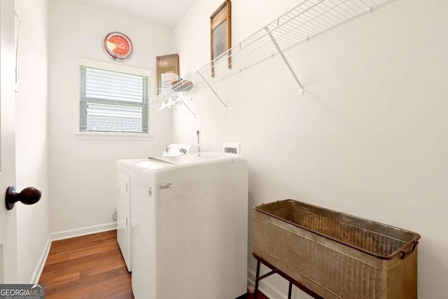 laundry room featuring washer and dryer and wood-type flooring