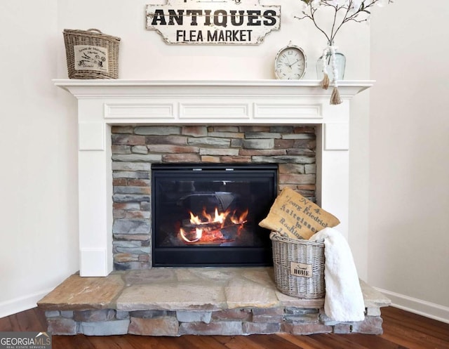 room details featuring a fireplace and hardwood / wood-style flooring