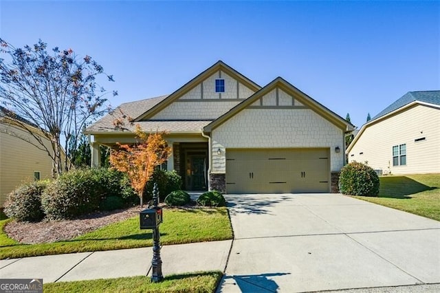 craftsman inspired home featuring a garage and a front lawn