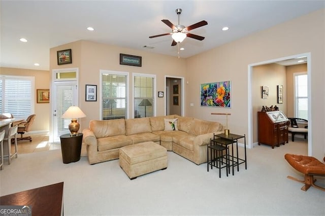 living room featuring ceiling fan and light colored carpet