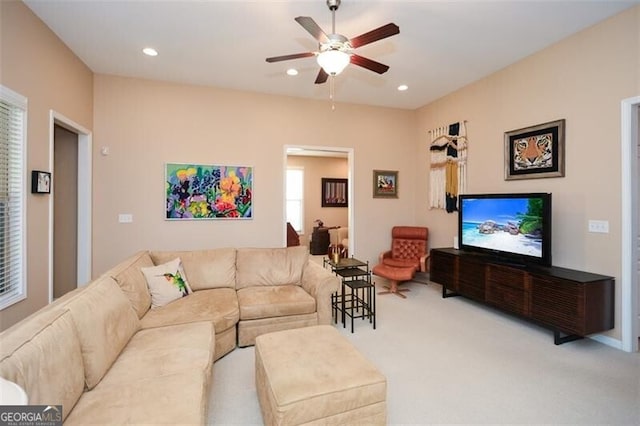 carpeted living room featuring ceiling fan