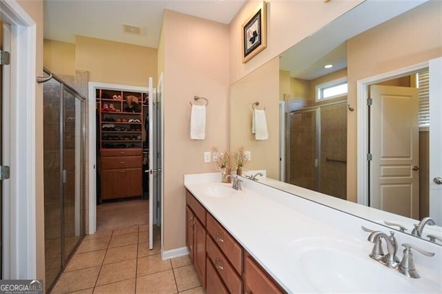 bathroom with vanity, tile patterned floors, and an enclosed shower