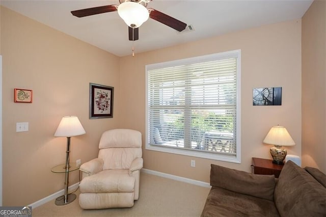 living area featuring ceiling fan and carpet floors