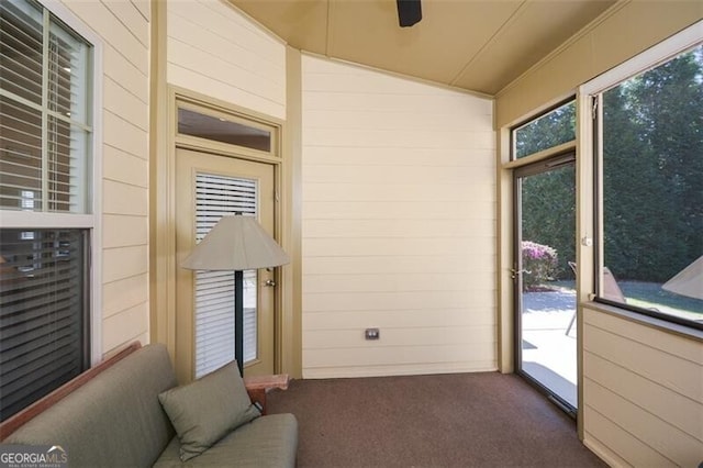 sunroom featuring vaulted ceiling