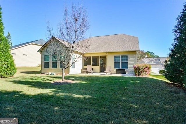 back of house with a patio area and a yard