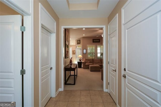 hallway featuring light carpet