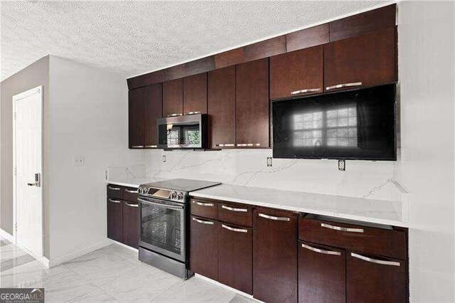 kitchen with backsplash, light stone countertops, a textured ceiling, dark brown cabinetry, and stainless steel appliances