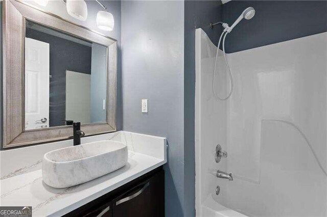 bathroom featuring vanity and bathing tub / shower combination