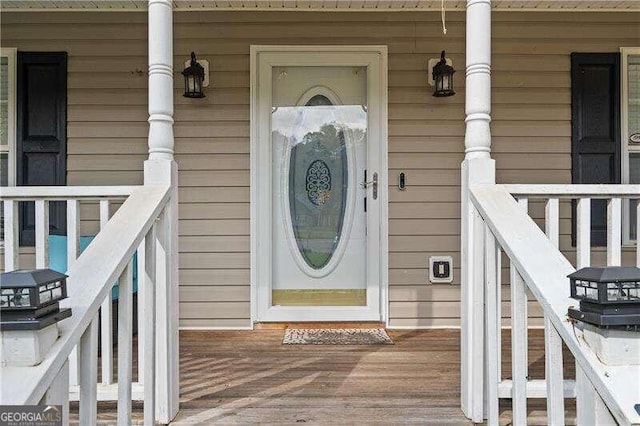 view of exterior entry with covered porch