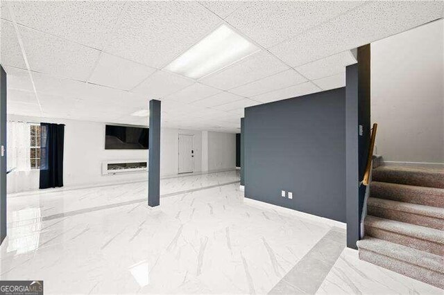 basement featuring a paneled ceiling