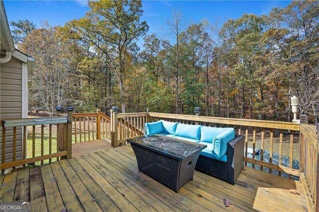 wooden terrace with outdoor lounge area