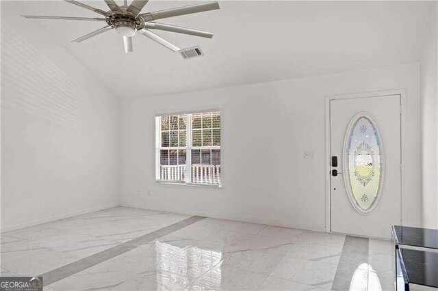 entryway with ceiling fan and vaulted ceiling